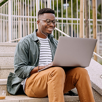 Man with headphones working on laptop